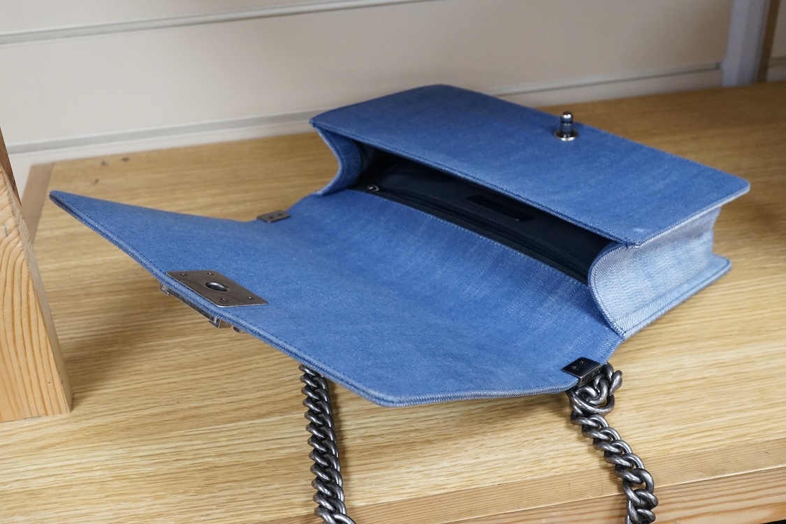 A Chanel denim cheveron flap shoulder bag with silver hardware, date code 20845697, 28cm wide
